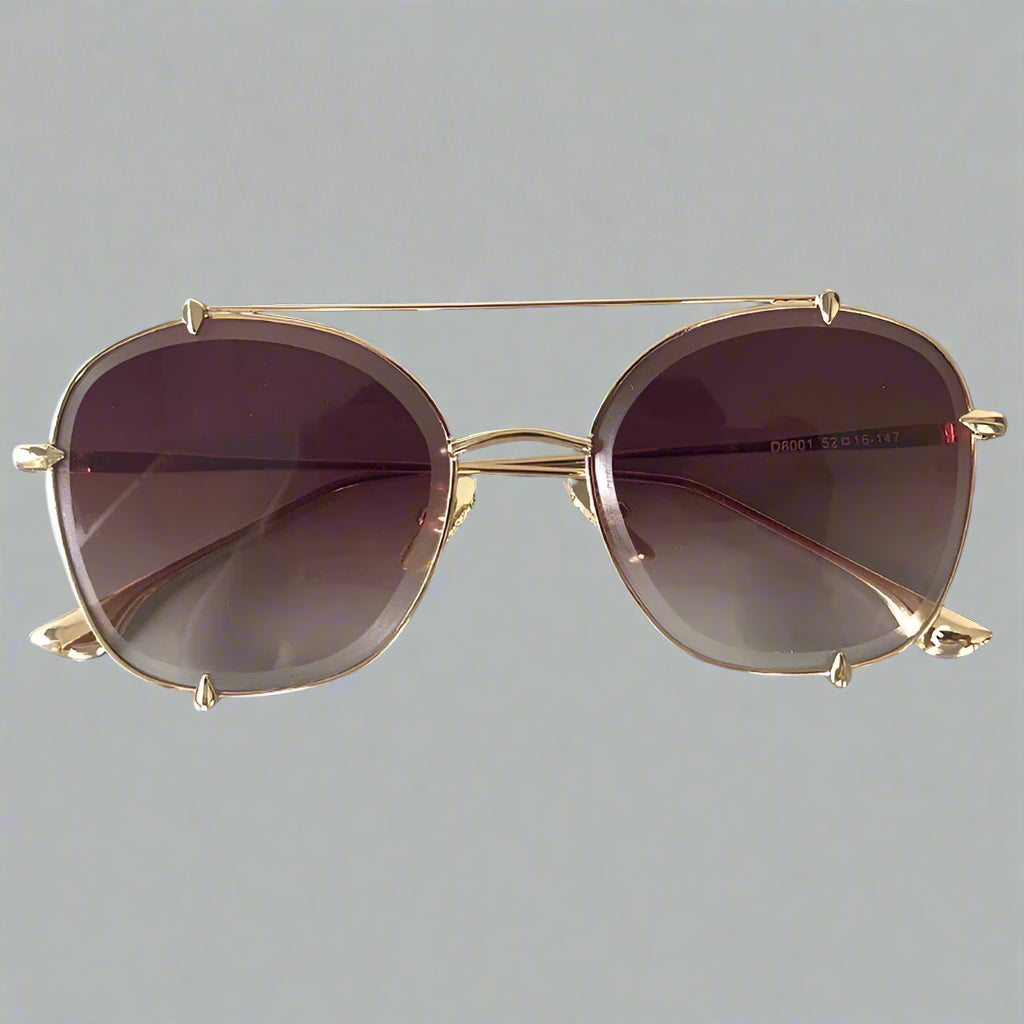 Gold-framed sunglasses with purple lenses on a gray background, branded 'CCSPACE'.