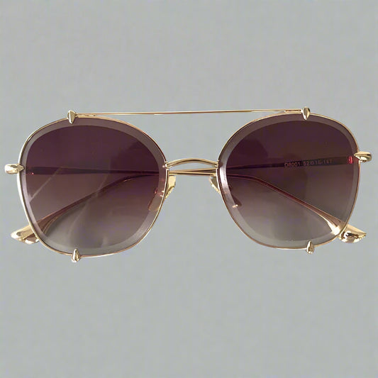 Gold-framed sunglasses with purple lenses on a gray background, branded 'CCSPACE'.