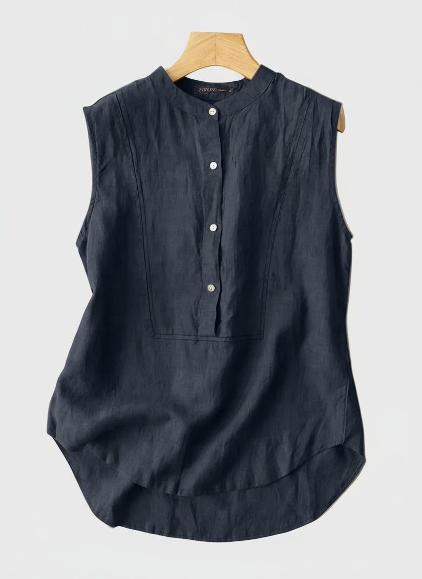 Navy sleeveless top on a hanger with a beige background