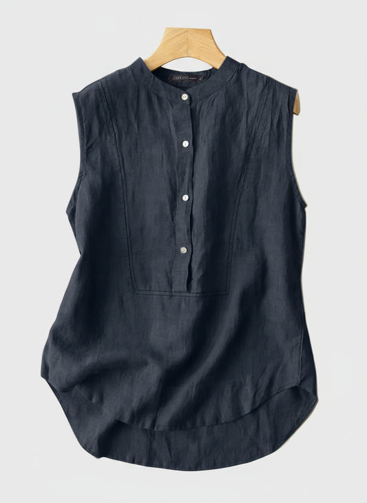 Navy sleeveless top on a hanger with a beige background