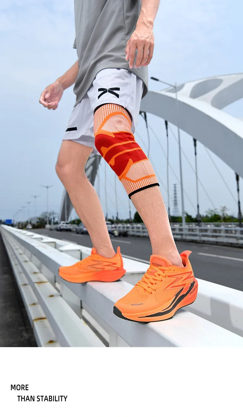 Person wearing orange running shoes and a knee brace on a bridge
