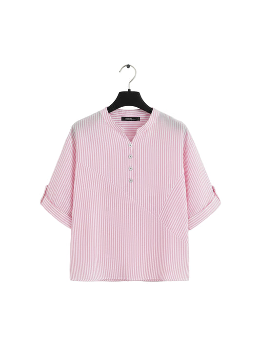 Pink checkered blouse on a hanger with a beige background