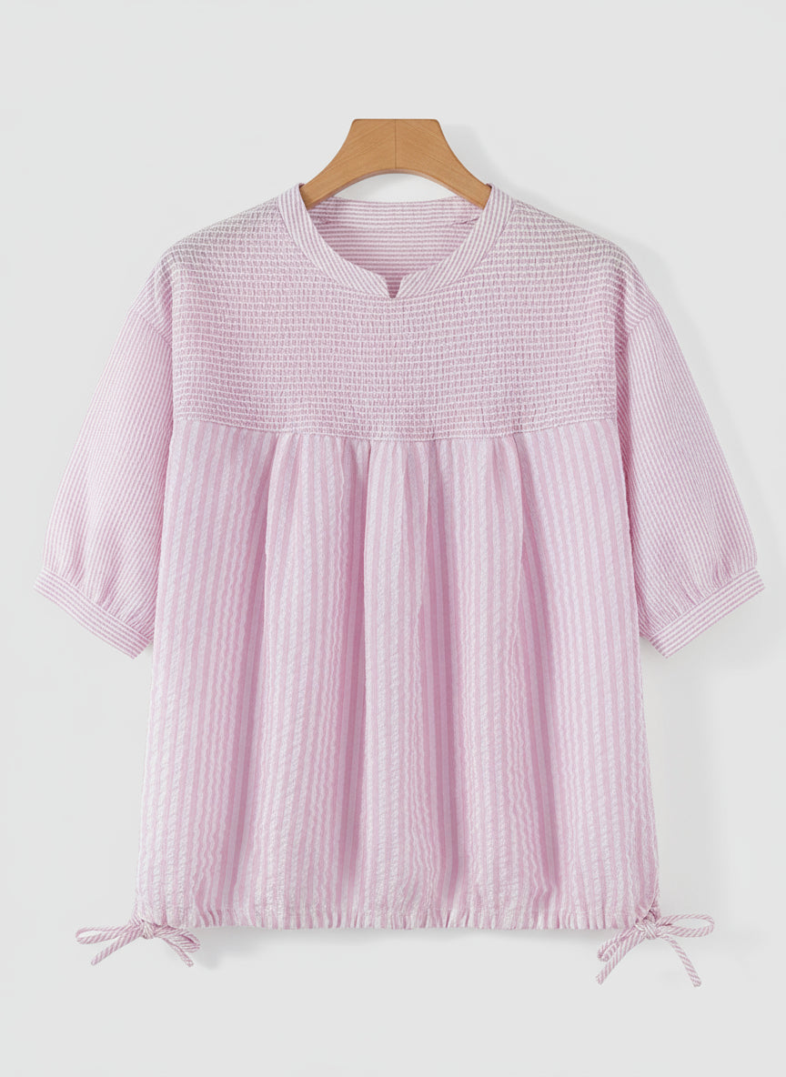 Pink textured blouse on a hanger with ZANZEA branding.