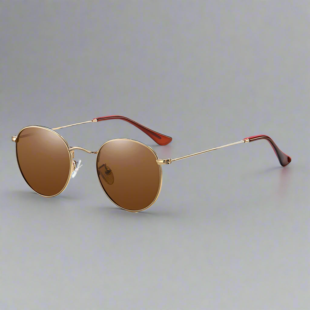 Round sunglasses with gold frame and brown lenses on a light blue background, featuring the WOWSUN brand.
