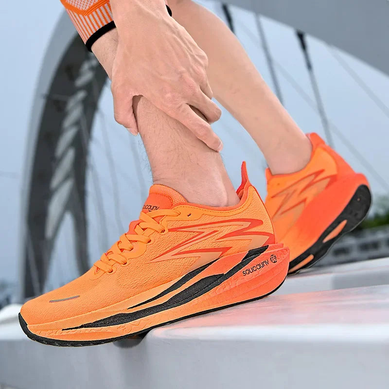 Person wearing bright orange running shoes with black soles, standing on a vehicle.